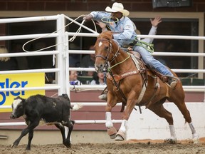 Cory Solomon of Prairie View, Tex., puts in the day's best tie-down roping score (6.7 seconds) on Day 6 of the Calgary Stampede Rodeo in Calgary, Alta., on Wednesday, July 13, 2016. Cowboys compete for 10 days for a piece of the rodeo's $2 million in prize money. Lyle Aspinall/Postmedia Network
