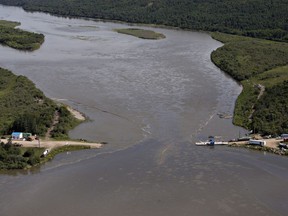 Crews work to clean up an oil spill on the North Saskatchewan river near Maidstone, Sask on Friday July 22, 2016. Husky Energy has said between 200,000 and 250,000 litres of crude oil and other material leaked into the river on Thursday from its pipeline.