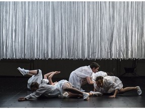 Dancers perform under an illuminated filament-square during Fernando Melo's Still at Banff Centre.