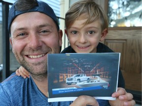 Dean Semeniuk and his son Kaden, 5 yrs pose in northwest Calgary, Alta on Wednesday July 20, 2016 with a photo of the truck and boat they won at the Calgary Stampede.