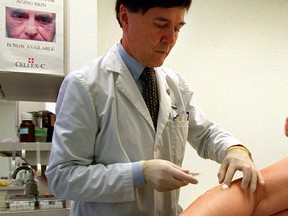 A file shot of a doctor treating varicose veins, which can strike young men.