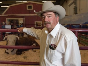 Doug Sawyer, a rancher from Alberta and past chair of the Alberta Beef Producers, poses with livestock on the Cattle Trail at the 2016 Calgary Stampede in Calgary, Alta., on Sunday, July 10, 2016.  Elizabeth Cameron/Postmedia