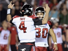 Calgary Stampeders quarterback Drew Tate (4) celebrates a kick by kicker Rene Paredes (30) against the Ottawa Redblacks to keep the game tied during overtime of a CFL football game in Ottawa on Friday, July 8, 2016.