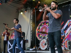Felix Riebl, left, and Harry James Angus perform with The Cat Empire on the main stage at the Calgary Folk Music Festival at Prince's Island in Calgary, Ab., on Sunday July 24, 2016. Mike Drew/Postmedia