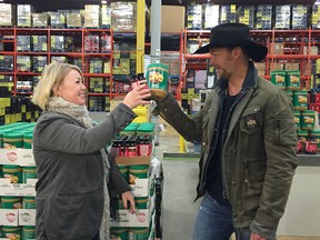 Calgary Stampede parade marshals Jann Arden, left, and Paul Brandt announce a "PB and J" donation to the Calgary food bank Monday, July 11 in Calgary.