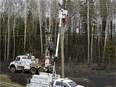 ATCO Electric workers repair power lines damaged by wildifre near Fort McMurray, Alberta on May 9, 2016.