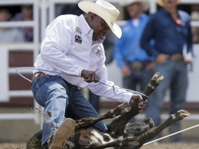 Fred Whitfield of Hockley, Texas, puts in the fastest time of the day (6.9 sec) in tie-down roping on Day 5 of the Calgary Stampede Rodeo in Calgary, Alta., on Tuesday, July 12, 2016. Cowboys compete for 10 days for a piece of the rodeo's $2 million in prize money. Lyle Aspinall/Postmedia Network