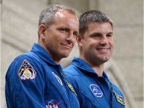 Canadian astronauts Jeremy Hansen (right) and David Saint-Jacques stand in the visitors gallery after being recognized in the House of Commons in Ottawa on Tuesday, June 2, 2015.