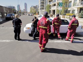 Calgary police officers and firefighters outside a homicide investigation scene in 300 block of 3 St SE.