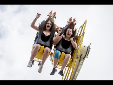 Raeleigh Aberg (L) and Laisa Kelly, both age 16, enjoy the Mach 3 ride on the midway during the Calgary Stampede Sneak-a-Peek in Calgary, Alta., on Thursday, July 7, 2016. Stampede would officially kick off the next day and last until July 17. Lyle Aspinall/Postmedia Network