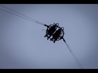 Riders of the Slingshot soar into the air on the midway during the Calgary Stampede Sneak-a-Peek in Calgary, Alta., on Thursday, July 7, 2016. Stampede would officially kick off the next day and last until July 17. Lyle Aspinall/Postmedia Network