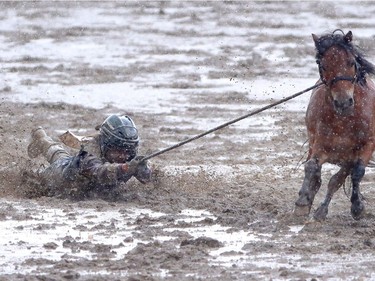It was a muddy day during the wild pony racing at the Calgary Stampede on Saturday July 16, 2016.