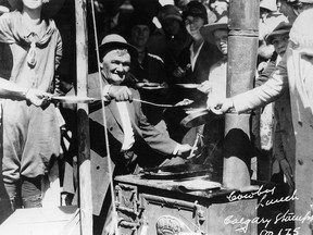 JULY 1923 - Horace Inkster, serving pancakes at Calgary Stampede street breakfast. from the Jack Morton wagon. Inkster was cook on Morton's CX  Ranch.