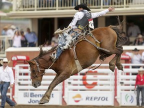 Jake Wright of Milford, Utah, rides Major Cover to the day's top score in saddle bronc on Day 6 of the Calgary Stampede Rodeo in Calgary, Alta., on Wednesday, July 13, 2016. Cowboys compete for 10 days for a piece of the rodeo's $2 million in prize money. Lyle Aspinall/Postmedia Network