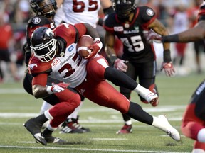 Calgary Stampeders' Jerome Messam (33) carries the ball against the Ottawa Redblacks during the first half of a CFL football game in Ottawa on Friday, July 8, 2016.