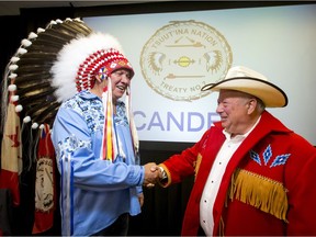 Jonathan Wener, CEO of the Canderel TsuutÕina partnership, shakes hands with Chief Roy Whitney during a press conference at the Grey Eagle Hotel on the southwest edge of Calgary, Alta., on Monday, July 11, 2016. Lyle Aspinall/Postmedia Network