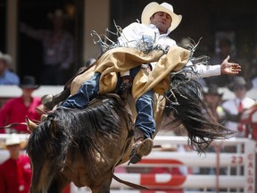 Kaycee Feild, of Elk Ridge, Utah, competes in the bareback event during rodeo action at the Calgary Stampede in Calgary, Alta., Friday, July 8, 2016.THE CANADIAN PRESS/Jeff McIntosh ORG XMIT: JMC130