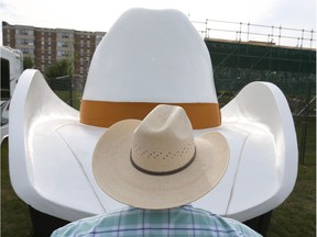 Keith Anderson examines a large-sized Smithbilt hat float during parade preparations at Fort Calgary in Calgary, Alta on Thursday July 7, 2016. Anderson and his crew will be pulling a group from the rodeo committee in the Stampede Parade on Friday morning.