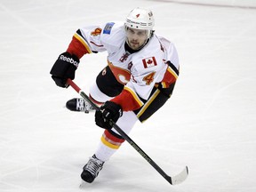 FILE - In this Nov. 24, 2015, file photo, Calgary Flames' Kris Russell moves the puck during the first period of an NHL hockey game against the Anaheim Ducks, in Anaheim, Calif.  On Monday, Feb. 29, 2016, Calgary sent Russell to Dallas for a relatively rich return of 24-year-old defenseman Jyrki Jokipakka, a prospect and a conditional second round pick in 2016.