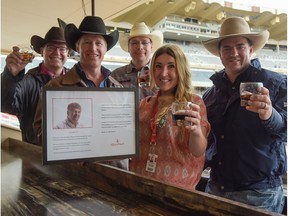 Kurt Kadatz, Rod Hay, Tim Ellis, Kristen Odland and Dustin Flundra toast Dwayne Erickson with rum and cokes, his favourite drink, inside the newly-named Dwayne Erickson Media Suite at the 2016 Calgary Stampede in Calgary, Alta., on Saturday, July 16, 2016. Erickson covered the rodeo for the Calgary Herald and Sun for over 30 years.