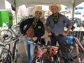 Leor Rotchild and Rob Ironside of DoitGreen are seen inside the bike valet near the Olympic Way entrance to the 2016 Calgary Stampede in Calgary, Alta., on Thursday, July 14, 2016. DoitGreen is offering the free phone charging and bike storage services for the duration of Stampede.