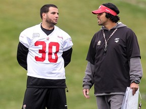 CALGARY, AB.; SEPTEMBER 16, 2015   -- Calgary Stampeders kicker Rene Parades speaks with special teams co-ordinator Mark Kilam during practice at McMahon Stadium Wednesday September 16, 2015 in advance of Friday's game against the BC Lions. (Ted Rhodes/Calgary Herald) For Sports story by Rita Mingo. Trax # 00068465A