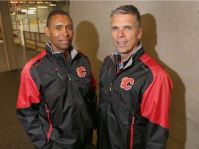 Newly named Calgary Flames assistant coaches Paul Jerrard (L) and Dave Cameron pose after an on ice session at the team's summer development camp at Winsport in Calgary, Alta. on Wednesday July 6, 2016. Jim Wells/Postmedia