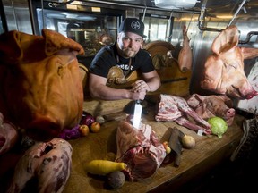 Chef Ryan O'Flynn poses for a photo inside a display case at The Guild in downtown Calgary, Alta., on Tuesday, July 19, 2016. Located in the Bay building on Stephen Avenue, The Guild is set to officially open on Thursday, July 21. Lyle Aspinall/Postmedia Network
