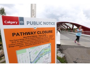 Pedestians travel near the south end of the Peace Bridge in Calgary, Alta on Thursday July 14, 2016. The popular cycling and pedestrian route will be closing later in July for repairs. Jim Wells//Postmedia