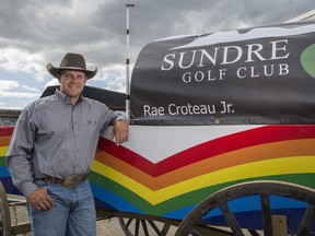 Crystal Schick/ Postmedia
CALGARY, AB -- Chuckwagon driver Rae Croteau Jr. stands next to his sponsorship tarp, Sundre Golf Club, on Day 1 of GMC Rangeland Derby at Calgary Stampede, on July 9, 2016. -- 
(Crystal Schick/Postmedia)