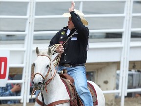 Clint Robinson of Spanish Fork, UT, with the victory lap after winning the day money in the  tie-down-roping event at the Calgary Stampede rodeo on Friday, July 8, 2016.