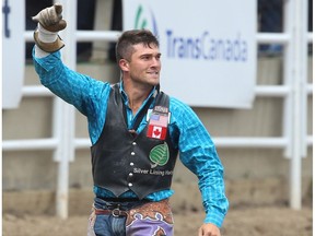 Utah cowboy Caleb Bennett celebrates after a 86 point ride on Sexy Bucks during the bareback event at the Calgary Stampede rodeo on Saturday, July 9, 2016.