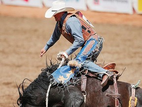 Hudson's Hope, BC cowboy Jake Watson rode Dark Side to a score of 84.00 on Day 4 of the Calgary Stampede rodeo saddle bronc event on Monday, July 11, 2016. AL CHAREST/POSTMEDIA