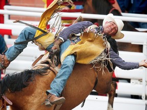 Texas cowboy Bobby Mote rode Buckskin Sally to a score of 86.50 on Day 4 at the Calgary Stampede rodeo bareback event on Monday, July 11, 2016. AL CHAREST/POSTMEDIA