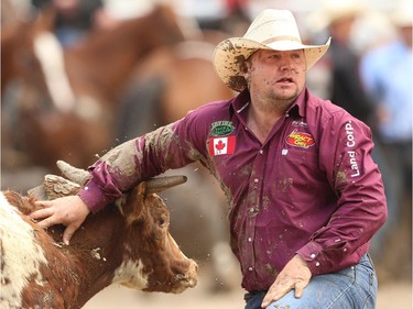 Pouce Coupe BC bulldogger Clayton Moore planted his steer in a time of 4.4 seconds to win top money on Day 9 of the steer-wrestling event at the Calgary Stampede rodeo on Saturday, July 16, 2016.