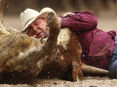 Pouce Coupe BC bulldogger Clayton Moore planted his steer in a time of 4.4 seconds to win top money on Day 9 of the steer-wrestling event at the Calgary Stampede rodeo on Saturday, July 16, 2016.