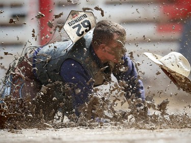 North Dakota cowboy Boyd Stroh is bucked off Say So Long during the novice saddle bronc event at the Calgary Stampede rodeo on Saturday, July 16, 2016.