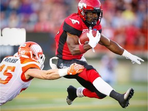 Calgary Stampeders Roy Finch avoids a tackle by Jason Arakgi of the BC Lions during CFL football in Calgary, Alta., on Friday, July 29, 2016.
