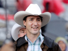 Prime Minister Justin Trudeau walks through the crowd during the start of the rodeo at the Calgary Stampede in Calgary, Alta., on Friday July 15, 2016.