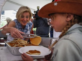 Premier Rachel Notley serves up pancakes at the Premier's annual Stampede Breakfast in 2015. This year's event goes Monday, July 11.