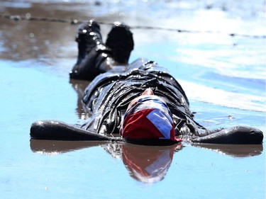 A competitor relaxes in the mud during the Rugged Maniac 5k Obstacle Race & Mud Run held at Spruce Meadows in Calgary, Alta on Saturday July 30, 2016. Jim Wells/Postmedia