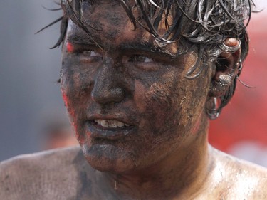 A muddy faced competitor catches his breath after completing the Rugged Maniac 5k Obstacle Race & Mud Run held at Spruce Meadows in Calgary, Alta on Saturday July 30, 2016.   Jim Wells/Postmedia