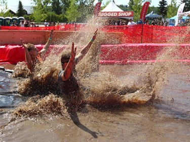 Competitors land in a mud puddle after clearing the last obstacle during the Rugged Maniac 5k Obstacle Race & Mud Run held at Spruce Meadows in Calgary, Alta on Saturday July 30, 2016. The event features about 30 different obstacles.  McIntosh completed the event in about 1:15:00. Jim Wells/Postmedia