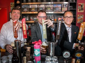 Alberta Minister of Agriculture and Forestry Oneil Carlier, left, Terry Rock, Alberta Small Brewers Association and  Minister of Finance and Treasury Board president Joe Ceci toast the new subsidies announced for small breweries at Village Brewery in Calgary, on Thursday, July 28, 2016.