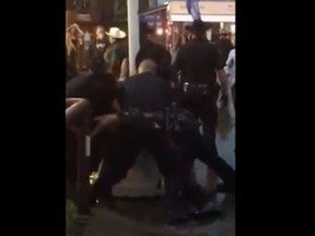 Screen grab from a video of a police takedown at the Calgary Stampede Wednesday, July 13, 2016.