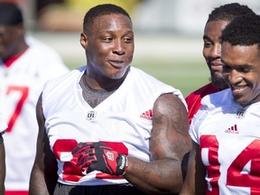 Micah Johnson chats with teammate Frank Beltre during the Calgary Stampeders training camp at McMahon Stadium in Calgary, Alta., on Tuesday, May 31, 2016. The regular season begins on June 25, when the Stamps head to B.C. Lyle Aspinall/Postmedia Network