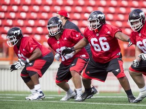 Ucambre Williams, far left, runs drills with other O-line hopefuls on the first day of Stampeders rookie camp in May.