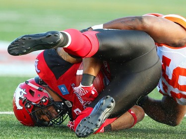 Calgary Stampeders Marquay McDaniel is tackled by Solomon Elimimian of the BC Lions during CFL football in Calgary, Alta., on Friday, July 29, 2016. AL CHAREST/POSTMEDIA