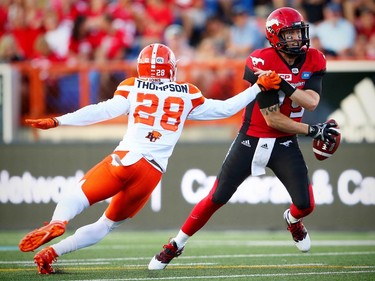 Calgary Stampeders quarterback Bo Levi Mitchell avoids a tackle by  Anthony Thompson of the BC Lions during CFL football in Calgary, Alta., on Friday, July 29, 2016. AL CHAREST/POSTMEDIA