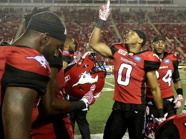 Calgary Stampeders Ciante Evans, right, celebrates his interception on the BC Lions with teammates during CFL action at McMahon Stadium in Calgary, Alta.. on Friday July 29, 2016. Leah Hennel/Postmedia